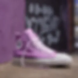 A vibrant display of light purple high top Converse shoes against a graffiti wall