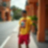 Trendy streetwear summer outfit featuring a vibrant graphic tee and relaxed shorts.