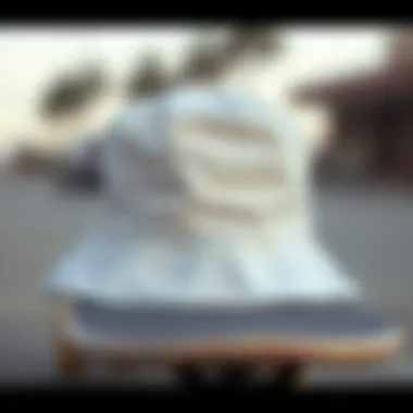 White Bucket Hat on a Skateboard Close-up of a white bucket hat placed on a skateboard
