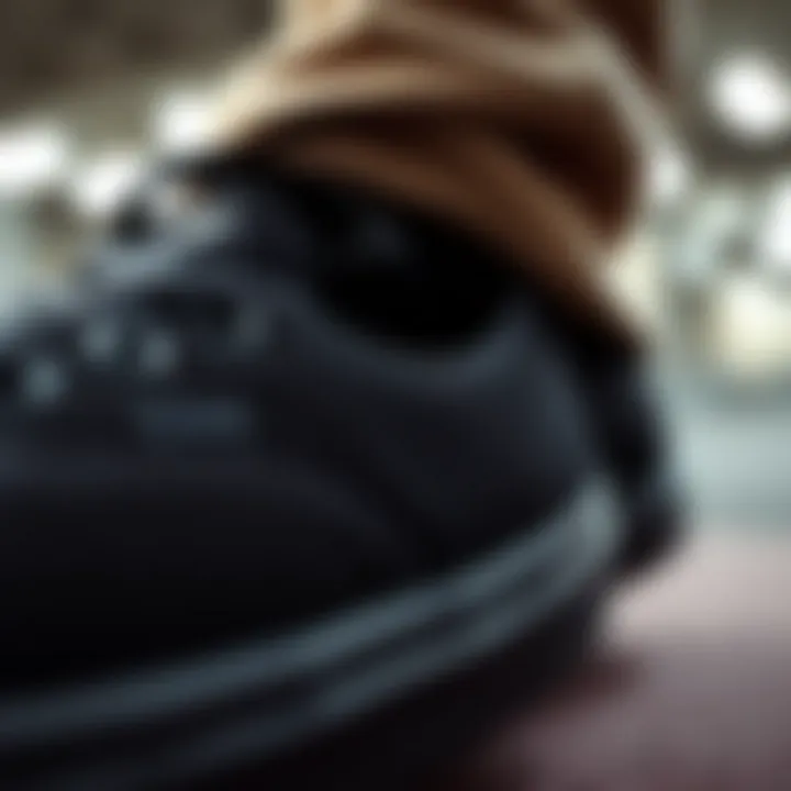 Detail View of Black Vans Design Features Close-up of black Vans shoes showcasing the texture and design elements.