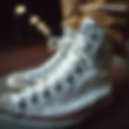 Close-up of unisex white high top Converse showcasing their iconic design.